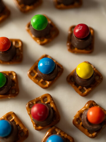 Chocolate peanut butter pretzel bites on a platter at a party.