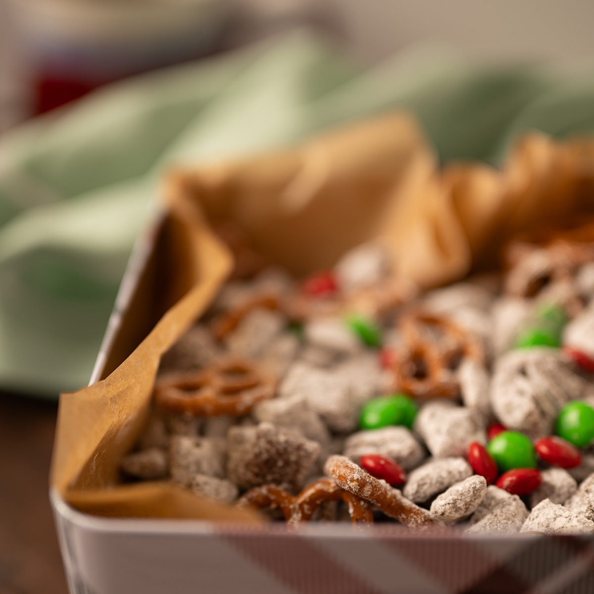 Reindeer chow with a green napkin and red mug of tea in the background.