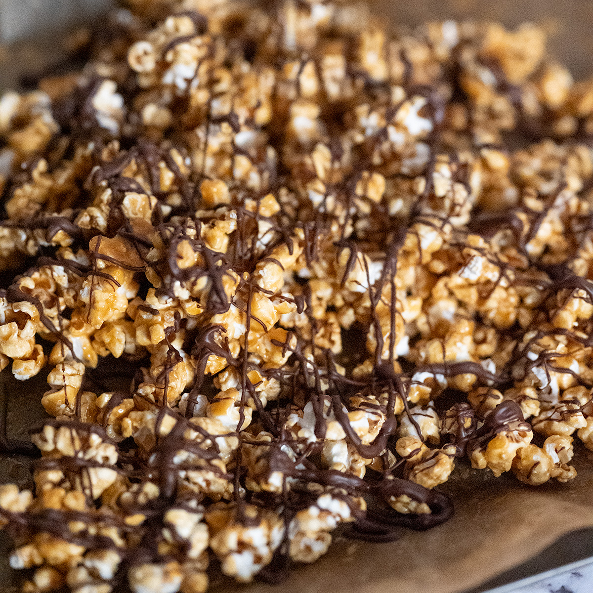 Streams of dark chocolate drizzled over caramel popcorn.